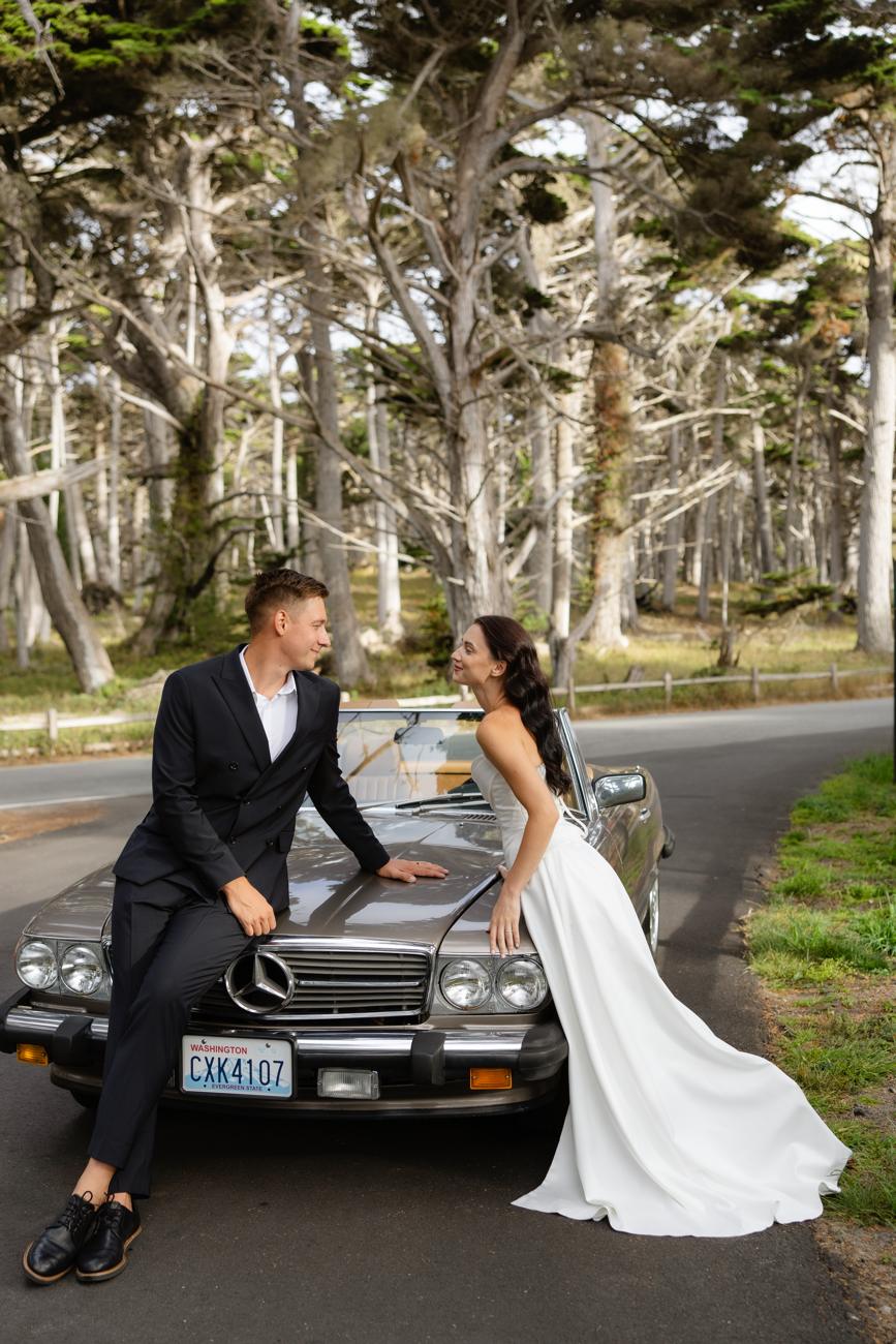 Couple sitting on the hood of the Mercedes