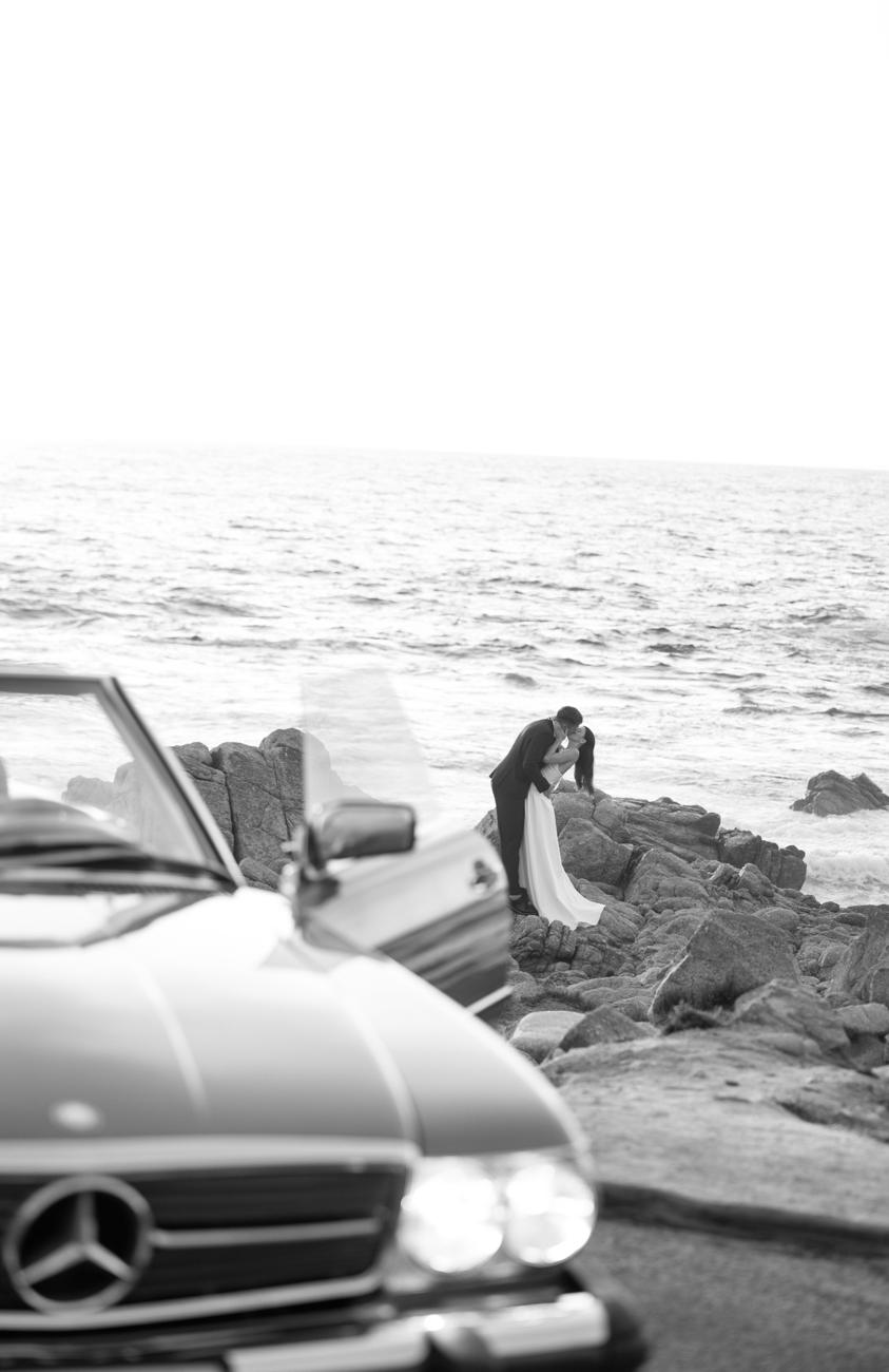 The Mercedes above the ocean rocks at sunset